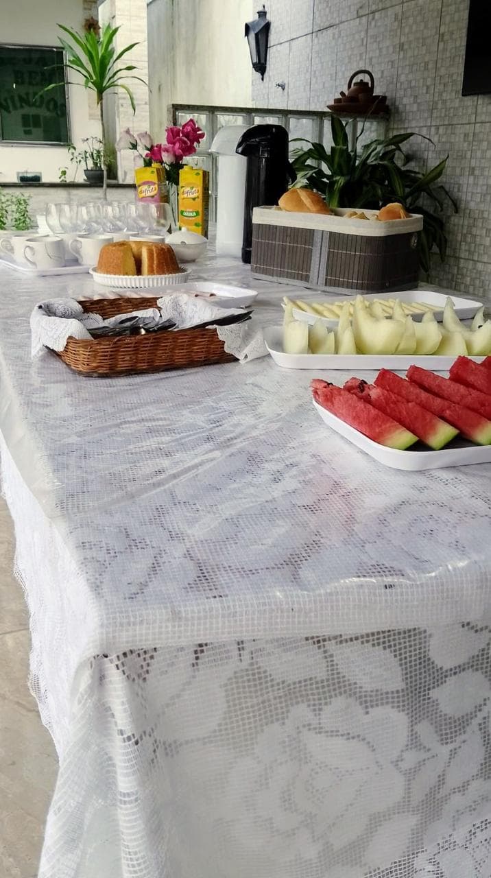 Mesa preparada com frutas e alimentos na Pousada Guimarães